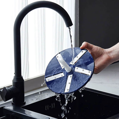 Blue wheel with metal spokes being rinsed under a black faucet in a kitchen sink.